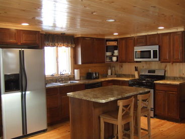 The Kitchen offers a breakfast bar, gas stove, microwave, fridge, dishwasher, utensils, pots & pans, and small appliances.