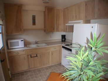 Fully Equipped with Microwave; Refrigerator; Stove; Coffee Maker; and the all important Blender. Service ware for 8