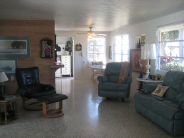 Living room with view of bay and pool