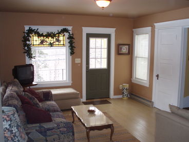 The living area has a large window which gives plenty of light. The couch is like a twin bed, large and very comfortable. There is also a over stuffed chair and ottoman. There is also a closet for coats.