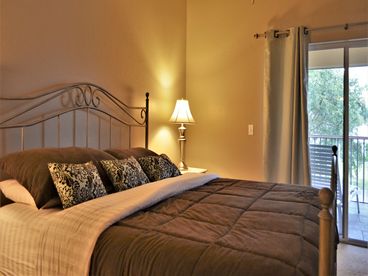 Master bedroom has king-sized bed and access to the patio, private shower bath, walk-in closet.