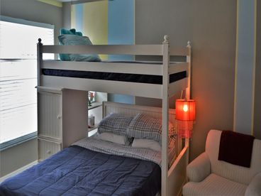 Guest bedroom has bunk bed with twin on top and double on bottom, private hallway and guest tub/shower combo bathroom.