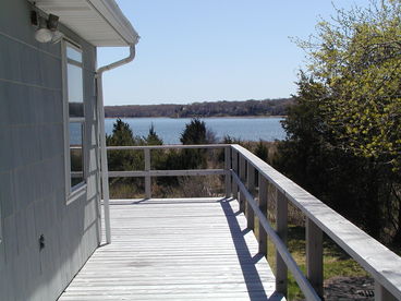 View of Harbor from side of house. There is now a cast aluminum bistro set against the house, so you can sit outside in the shade sometimes when the main deck is too bright.