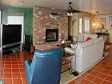 Big Screen TV and fireplace.