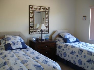 Guest room with twin beds and bathroom just outside and large walkin closet