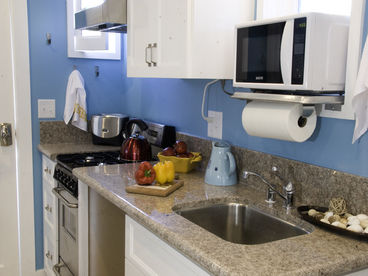 Full kitchen with Four Burner Stove and Oven, microwave, toaster and dishwasher