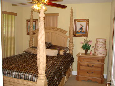 Queen size bed in bedroom.