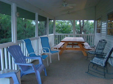 Screened, Covered, and Carpeted Porch  w/ plenty of seating and gas grill