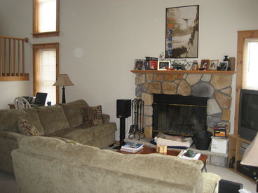 View of Living Room from Dining Room with wood burning fireplace