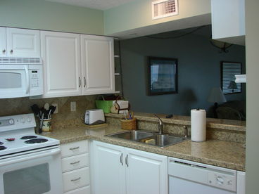 Fully Equipped Kitchen with washer/dryer and dishwasher. Brand New Cabinets, Countertops and Travertine Tile.