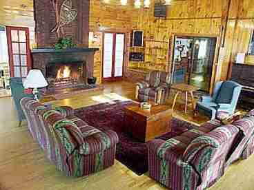 This large recreation room is a favorite
gathering place for guests. Accented with
knotty pine paneling, hardwood floors and a spectacular floor-to-ceiling fireplace, our
Great Room is the perfect place to relax and unwind.  A CD/cassette system is available for your entertainment pleasure. 