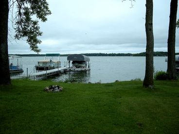 View of shoreline, firepit & dock. Pontoon available for rent.