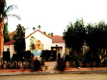 Hilltop Desert Contemporary overlooks valley, Palm Springs and Rancho Mirage. Desert Garden, Shade Trees, Architectural Lighting compliment entrance. 2 car garage.