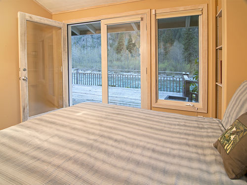 Spacious master bedroom with private entrance from deck, and stunning views of the river!