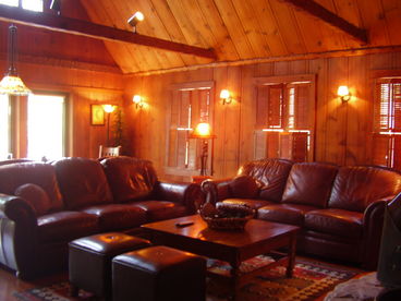 The Knotty Pine Great Room with Open Beamed Ceilings is a great place to gather in front of the fire.