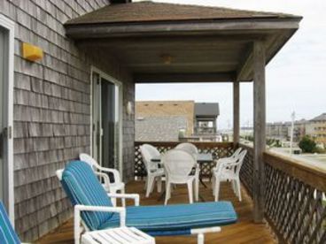 Deck with lounge chairs and outdoor dining.