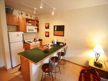 Full kitchen with seating at bar countertop