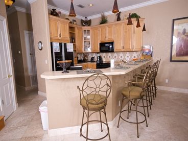 Fully Equipped kitchen with breakfast bar that adds 5 additional seats for dining