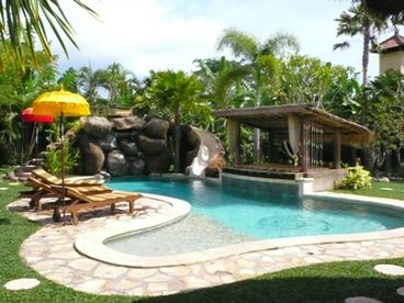 Luxurious Bali Villa Vacation Home Rental � Rumah Santai with a water slide pool.