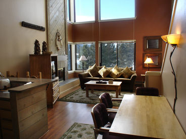 Dining area and living room with high ceilings