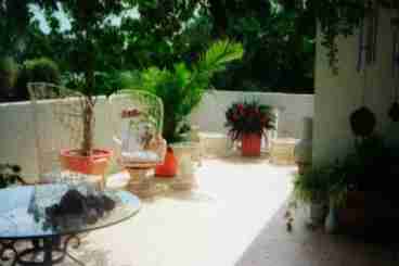 Front patio is decaorated with many fine floral plants and also has a  your own private barbecue.