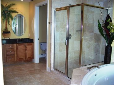 Large bath with jetted tub, separate shower, double vanity, private water closet plus huge walk-in closet that makes a  great space for a pack n play