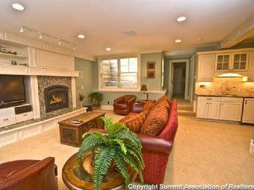 Lower living area with fireplace, flat screen tv, wet bar