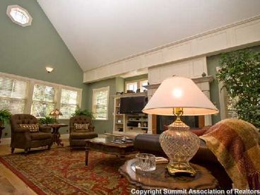 Main level living room with flat screen and fireplace