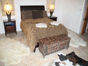 Master bedroom. What you can\'t see are views of the Jemez, a kiva fireplace and dresser with mirror.