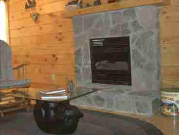 The hand laid stone fireplace will keep you warm on cold nights.
