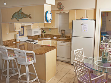 Updated fully equipped kitchen with granite countertops and stainless steel sink