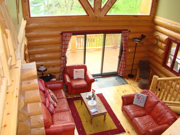 The warm and inviting living room opens on to a 1,200 square foot wrap-around cedar deck.