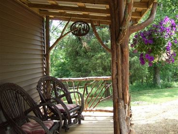 Coyote Hollow has a sitting porch on the front and a screened in porch on the back