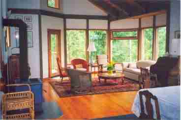 Vaulted ceilings, wood floors, and cozy wood stove. There's a door onto the large sundeck from which you can enjoy the afternoon sun.
