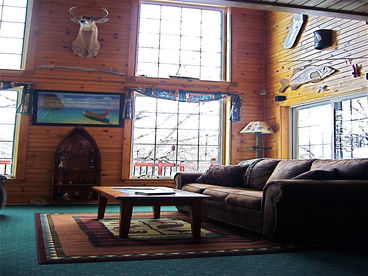 Leather couch for watching the big game on the LCD Flat-screen TV.  Dramatic vaulted ceilings and huge picture windows yield a great view of the lake.