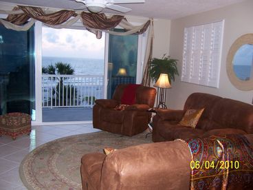 Living room overlooks gulf of mexico with microfiber easy chair and two loveseats. Sit back and watch the LCD or surf the internet. Or just  watch the beach scene.