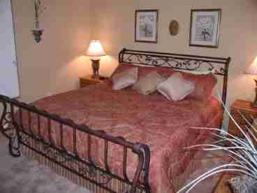 This large bedroom has a wonderful metal sleigh bed, premium furnishings, cable TV, DVD player and a feature window with views over the conservation area.