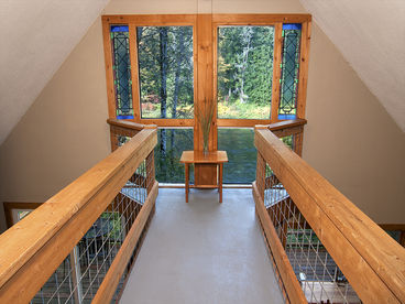 The upstairs loft leads to the unique view balcony that showcases amazing river views.
