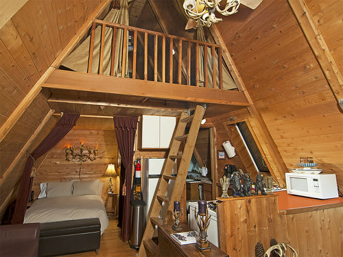 Upstairs sleeping loft with king size bed, and sleeping partition downstairs with queen size bed.