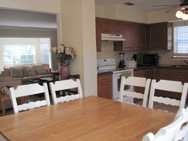 Dining area with view of kitchen and living room.