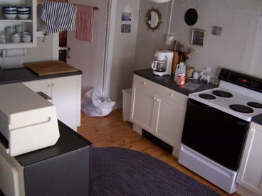 Ikea kitchen is very well-equipped with Cuisinart, cookbooks, etc., as this is a family home too. Separate pantry top left.