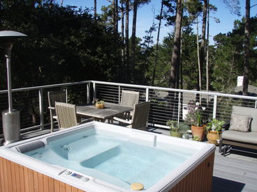 Enjoy a glass of wine in the hot tub while gazing out at the pine forest and peak of Monterey Bay