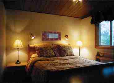 Snuggle into the fluffy duvet with country linens. The master bedroom also features a ceiling fan and double closet.
