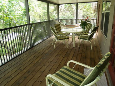 Large porch with hammock and dining set.