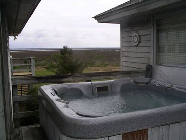The hot tub is on the deck.  The water is changed every day.