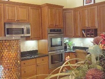 Cherry wood cabinets, stainless steel appliances and granite kitchen