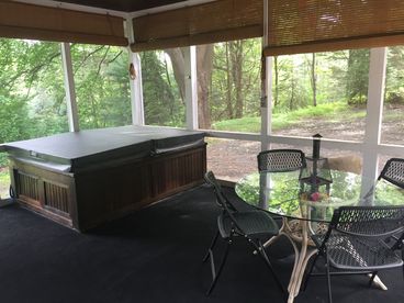 SCREENED PORCH WITH HOT TUB AND TABLE 