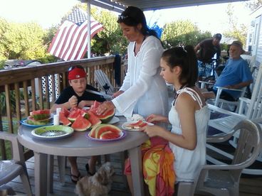 Family Having Watermelon On The Deck