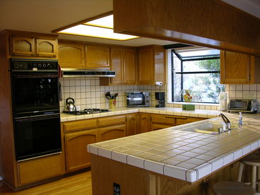 Fully equipped kitchen also has breakfast bar seating.