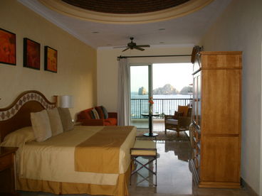 Large master bedroom with unique 20-foot domed ceiling with accent lighting.  The master suite opens to the wrap-around terrace with views of the pool, ocean and El Arco.marble ensuite.